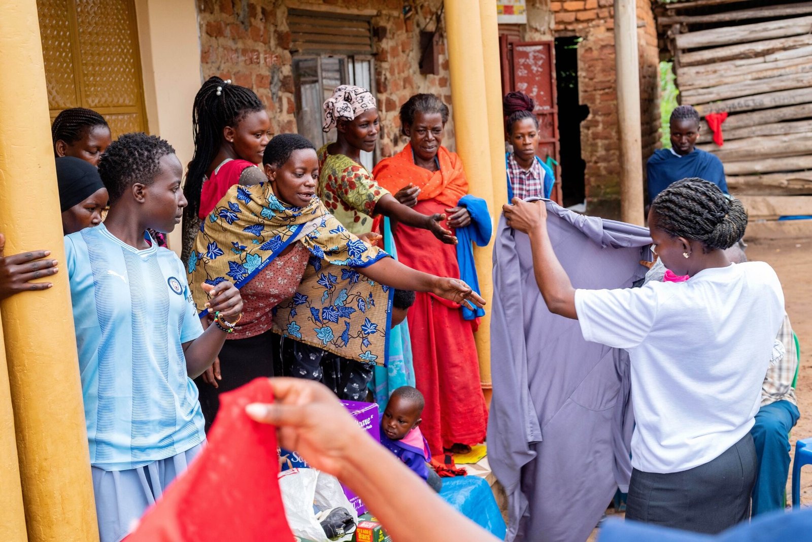 Women receiving menstrual health supplies during a community outreach